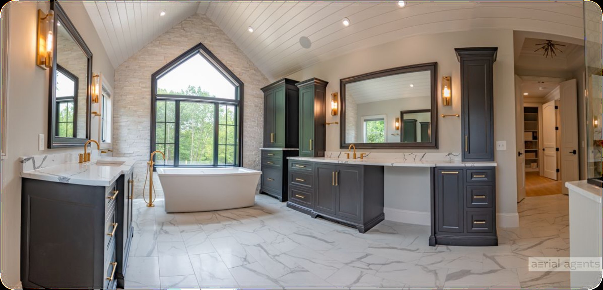 Finished bathroom with freestanding tub and custom cabinetry